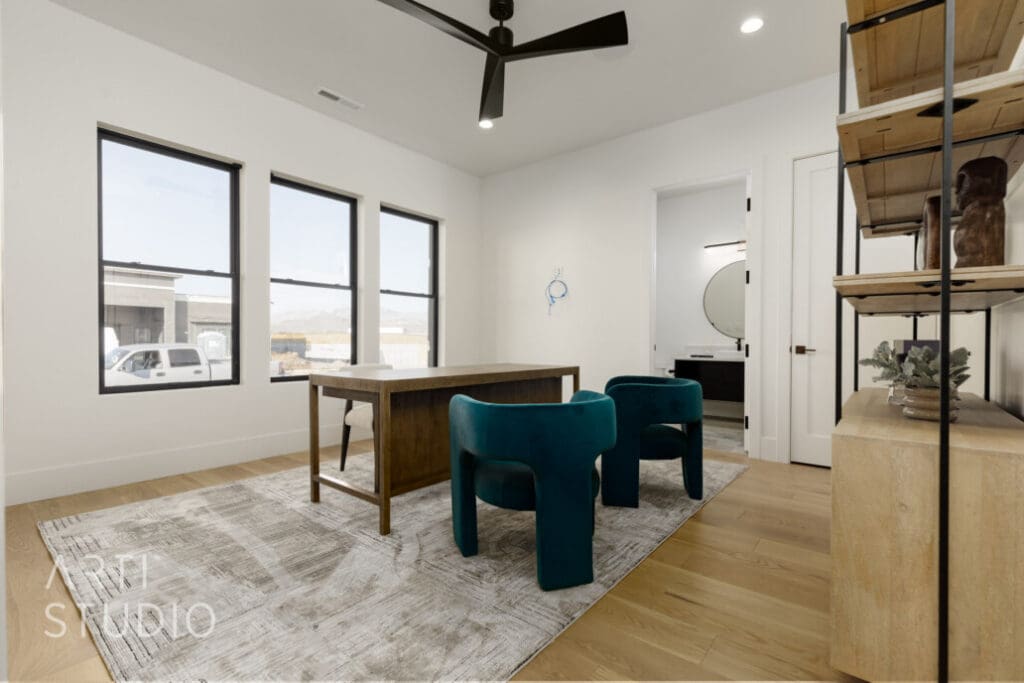 Office space featuring a wooden desk, turquoise chairs, and ample natural light from large windows.