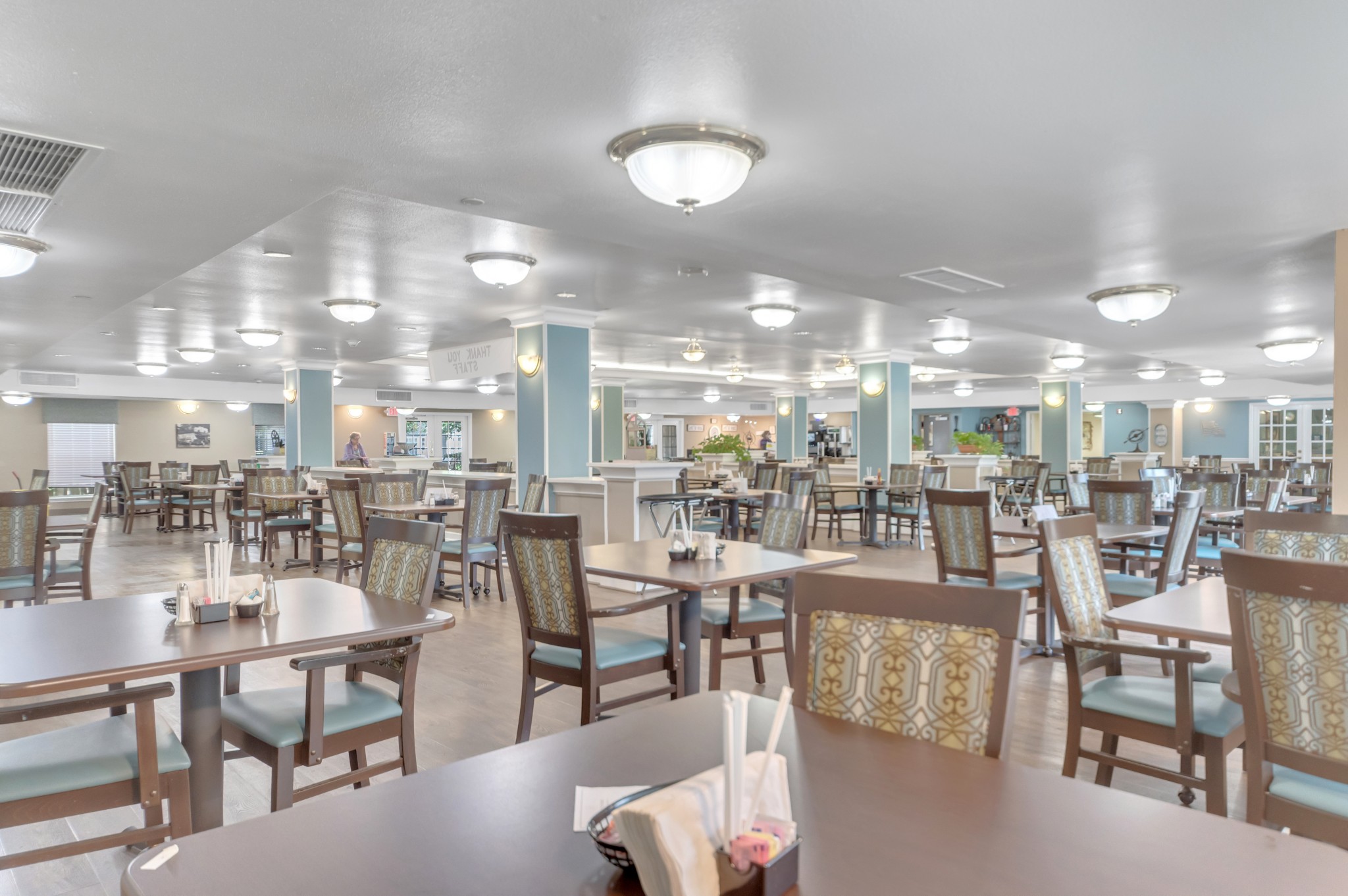 DSC_4888 - Grace Management Interior shot of Collier Park's large dining room with lots of seating and tables.