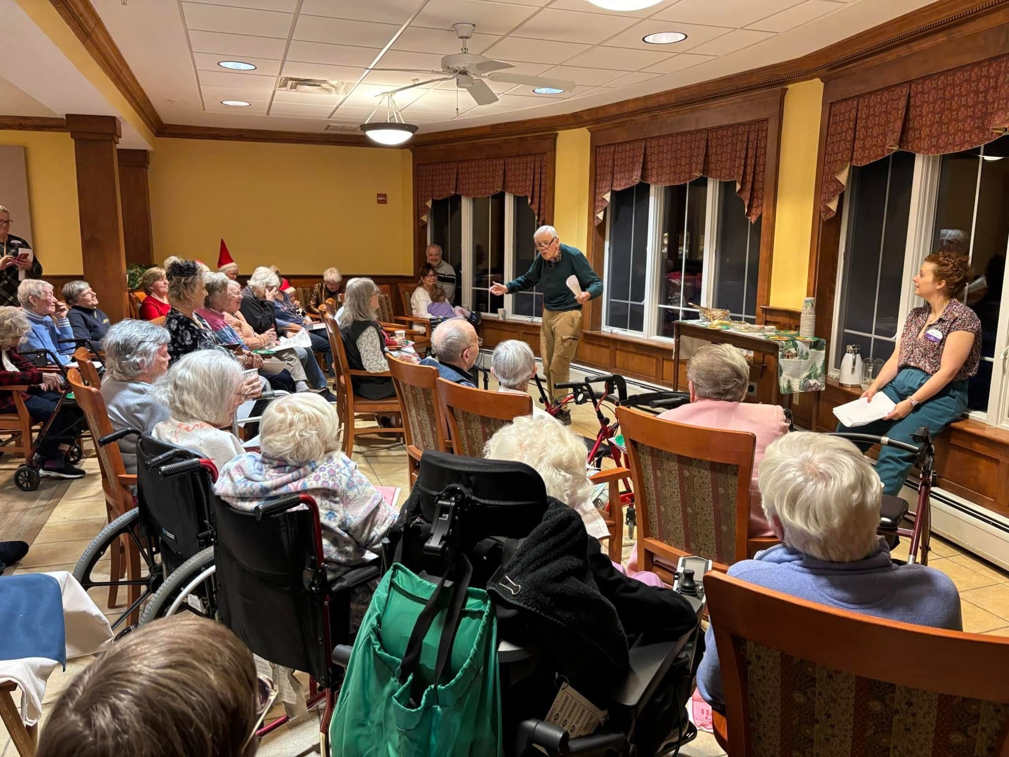 LifelongLearningInTextImage_Blog - Grace Management Engaged seniors listen attentively to a speaker, fostering community and connection in a bright, welcoming gathering space.