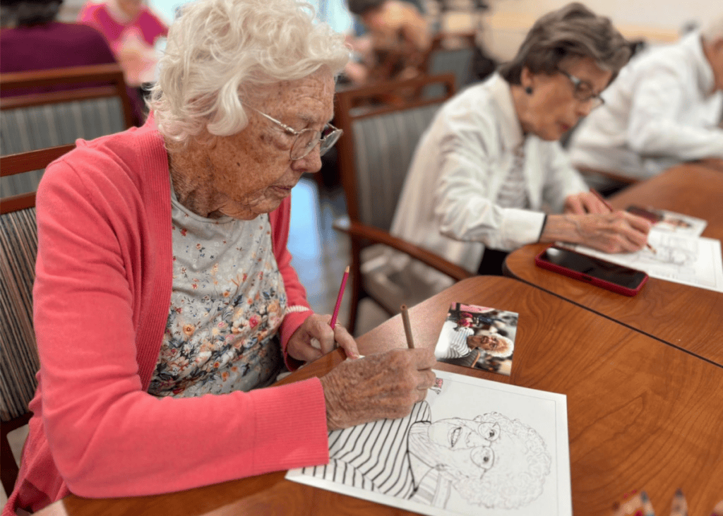 Residents engage in a creative coloring activity, showcasing vibrant expressions and camaraderie in a welcoming environment.