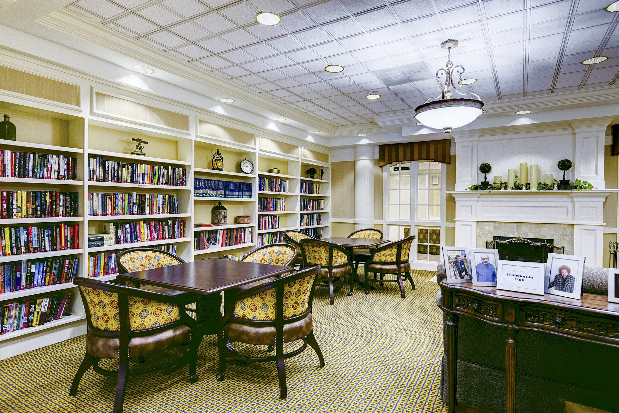 brookdale-northbrook-2-library - Grace Management Inspirations of Northbrook library room with seating and games and tables for socializing.