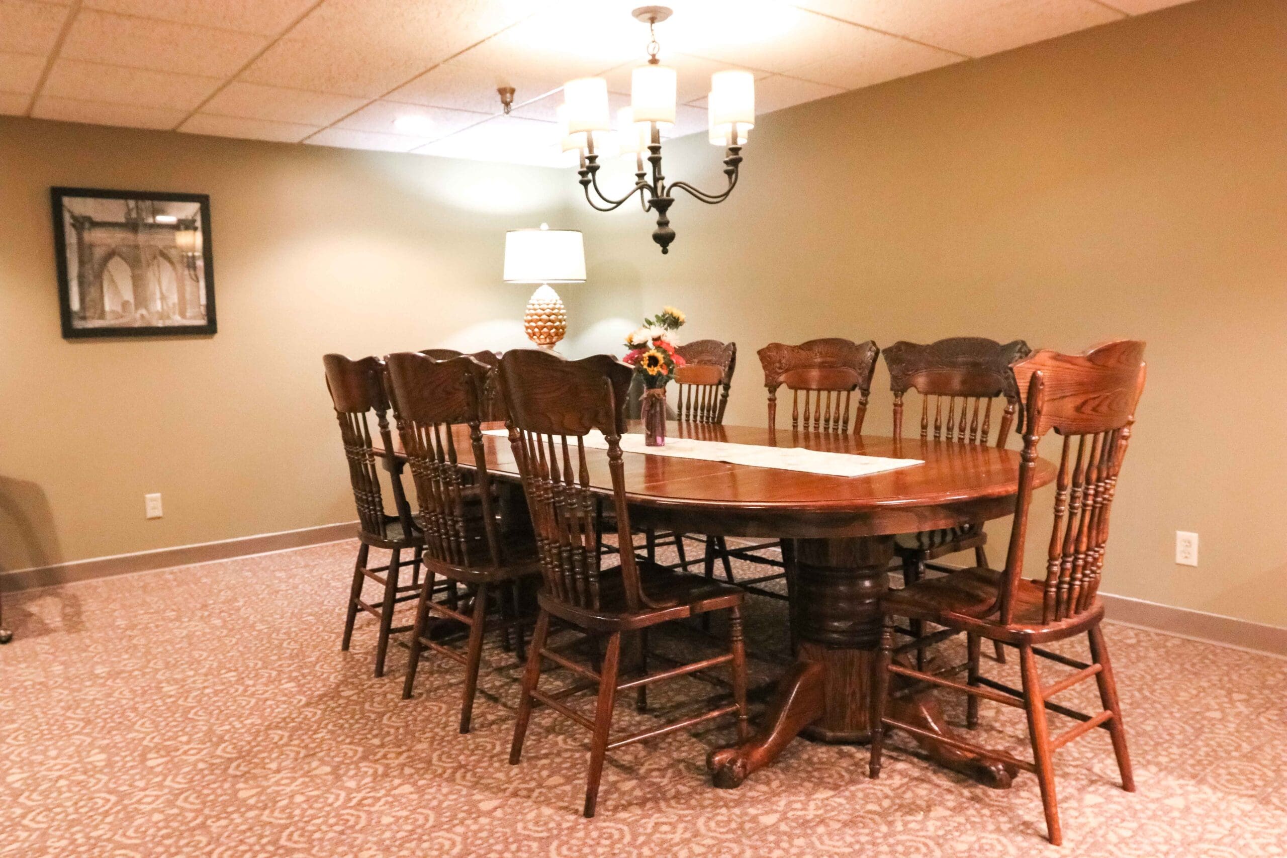IMG_9678-scaled - Grace Management Interior image of the formal dining room with a sturdy wooden table and 8 chairs at Inspirations of Northbrook.