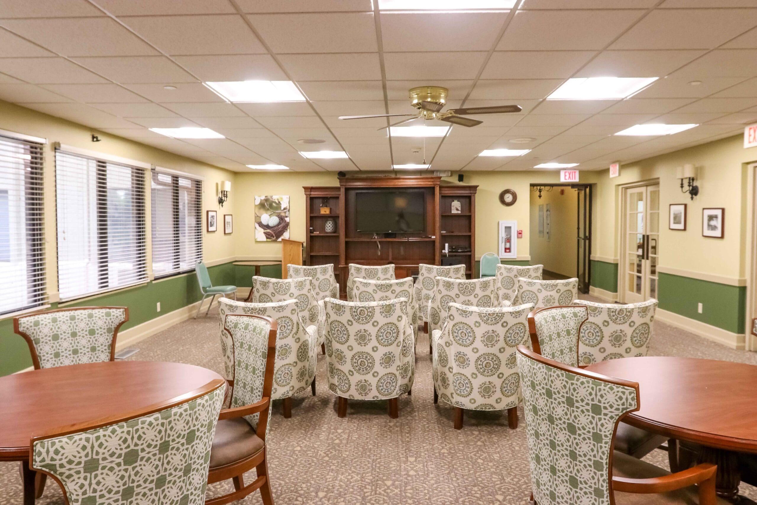 Interior image of the common room where chairs are set up to watch television together at the Inspirations of Northbrook.