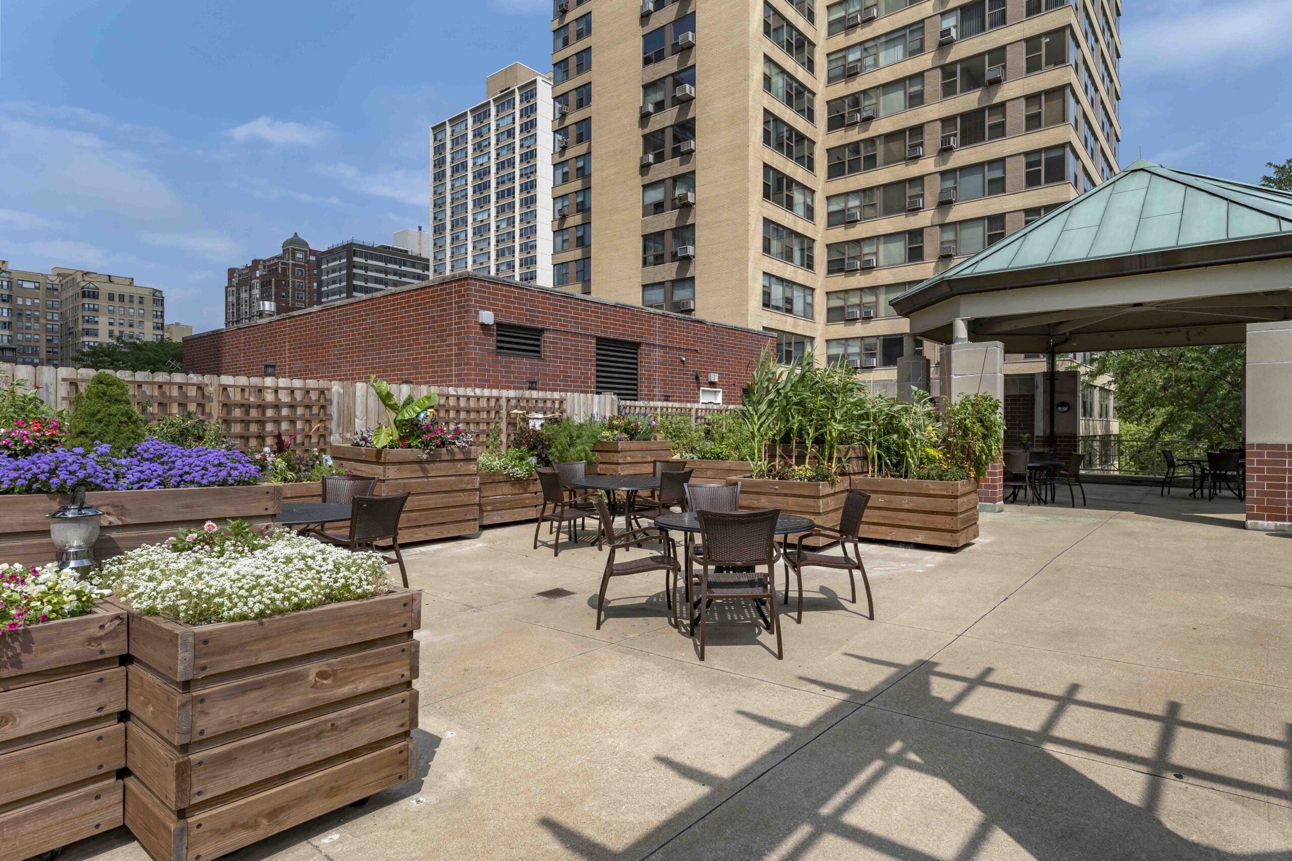 CS3_0012 - Grace Management Exterior image of The Hallmark patio with raised garden beds and comfortable seating.