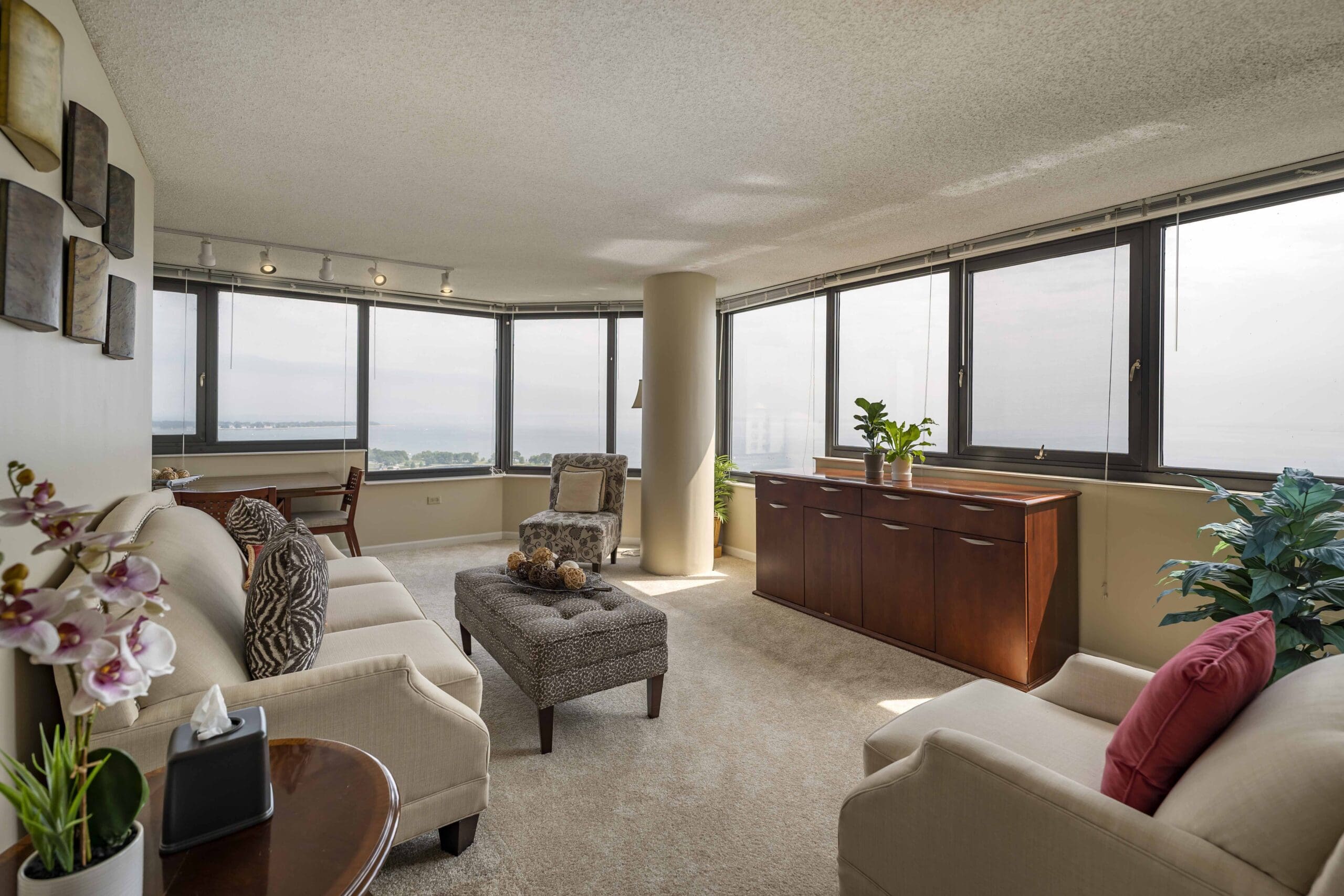 Resident apartment at The Hallmark, a living room with big windows and natural light.