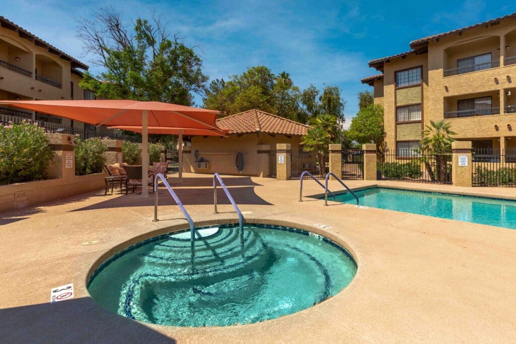 Pool, hot tub, and courtyard outside at Inspirations of Mesa.
